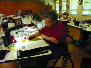 Sr. Linda Schoenborn is creating Hesychia during an icon writing workshop.