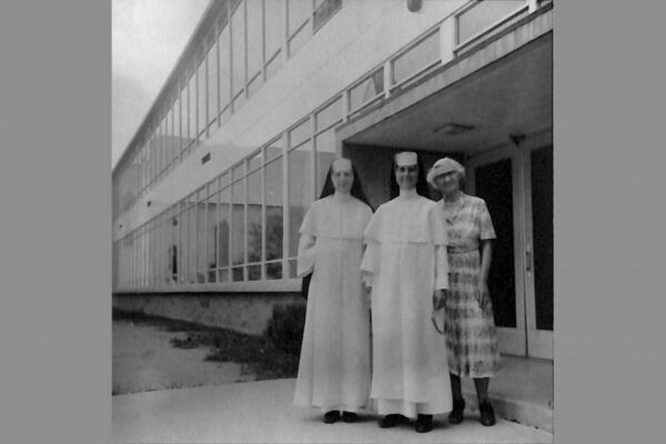 Sister Paschal is pictured in the center with Sister Andrea Zahm to the left and Sister Pascal's mother on the right. The photo was taken in 1959 in front of St. Francis in Traverse City, Michigan.