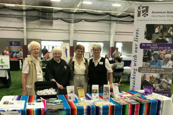 At Aquinas College in Grand Rapids, Michigan, Dominican Sisters engage with students during Saint Stock. Sisters Ann Mason, Joan Thomas, Rosemary O'Donnell, and Megan McElroy welcome students to learn more about the Dominican charism.