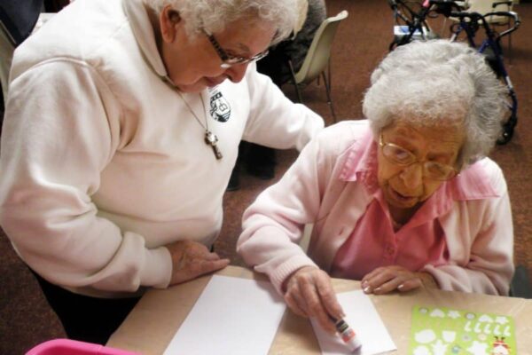 Sister Lupe with her blood sister Juanita at Aquinata Hall. During the final years of Juanita's life, Sister Lupe was her daily companion for walks around Marywood, reading, prayer and more.