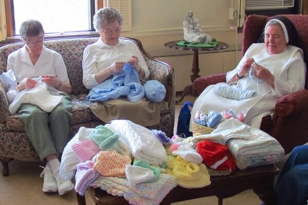 Each year a group of Sisters, including Sr. Geneva Marie (far right), crochet baby blankets, booties, and hats to donate to HELP Pregnancy Crisis Aid.