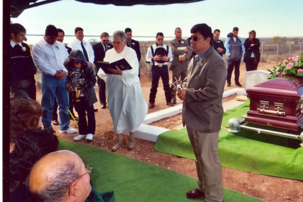 Sister Teresita prays at a funeral.