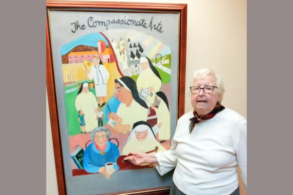Sr. Joan with her painting “The Compassionate Arts”