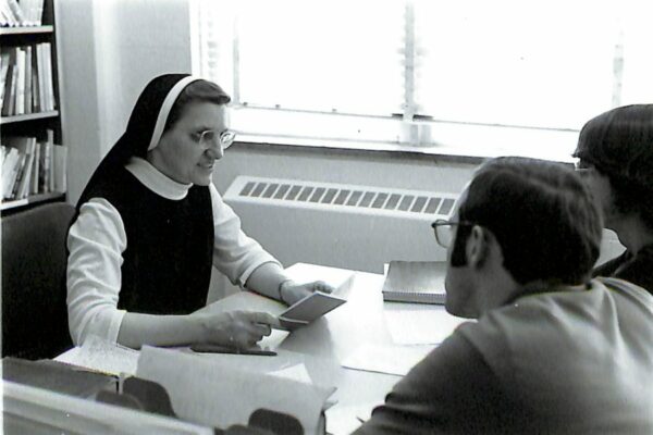 Sister Thomasine tutoring students in German at the Foreign Language Department at Aquinas around 1970