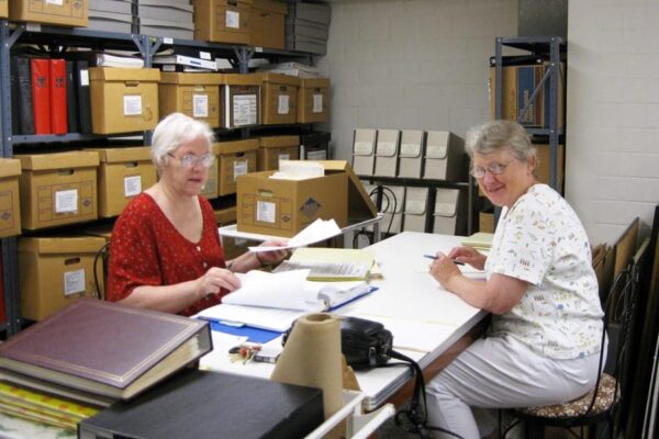 Sister Carm assists Sister Mary Pat Beatty with a history project.