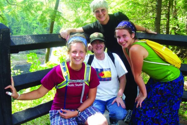 Sisters Kathi Sleziak OP and Chris Wood, OP enjoy a hike around Tahqamenon Falls with women of the Benincasa Community at Marywood. Benincasa was a Grand Rapids Dominican program for women who wished to discerne their vocation while living in community with Dominican Sisters.