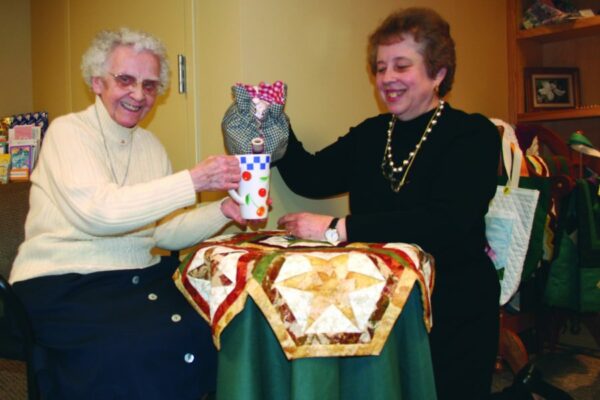 Sisters Louisa Mogdis and Joellen Barkwell have tea.
