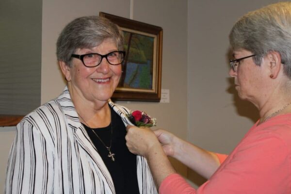 Sister Joan Foley celebrates Jubilee as Sr. Megan pins her corsage.