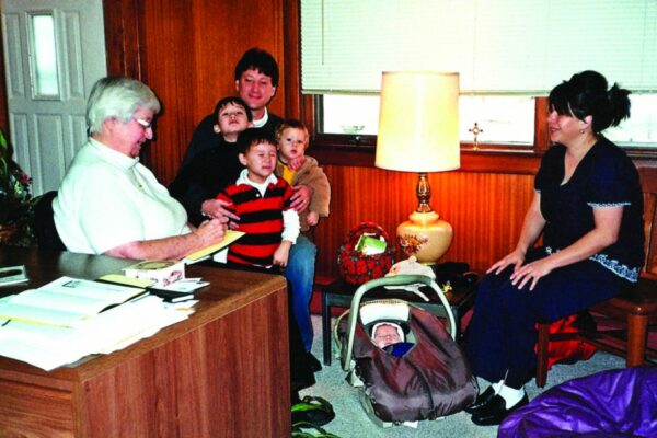 Sister Tereska prepares a family for the baptism of their new baby.