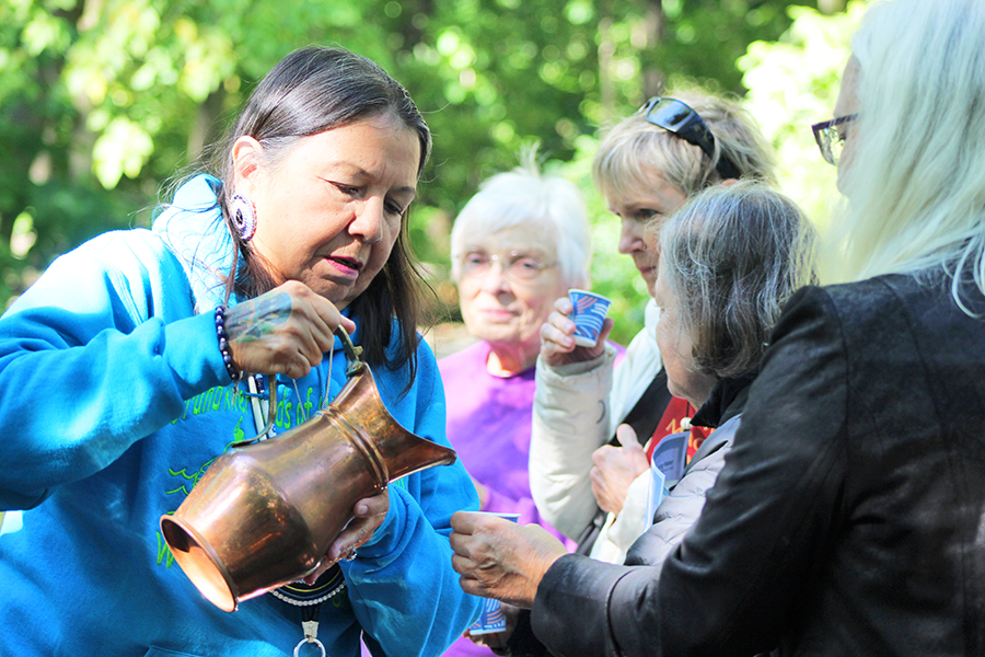 Morningstar/Kelly poured the blessed, pure water into Coldbrook Creek. She then poured the pure water into cups for all to bring into their own bodies